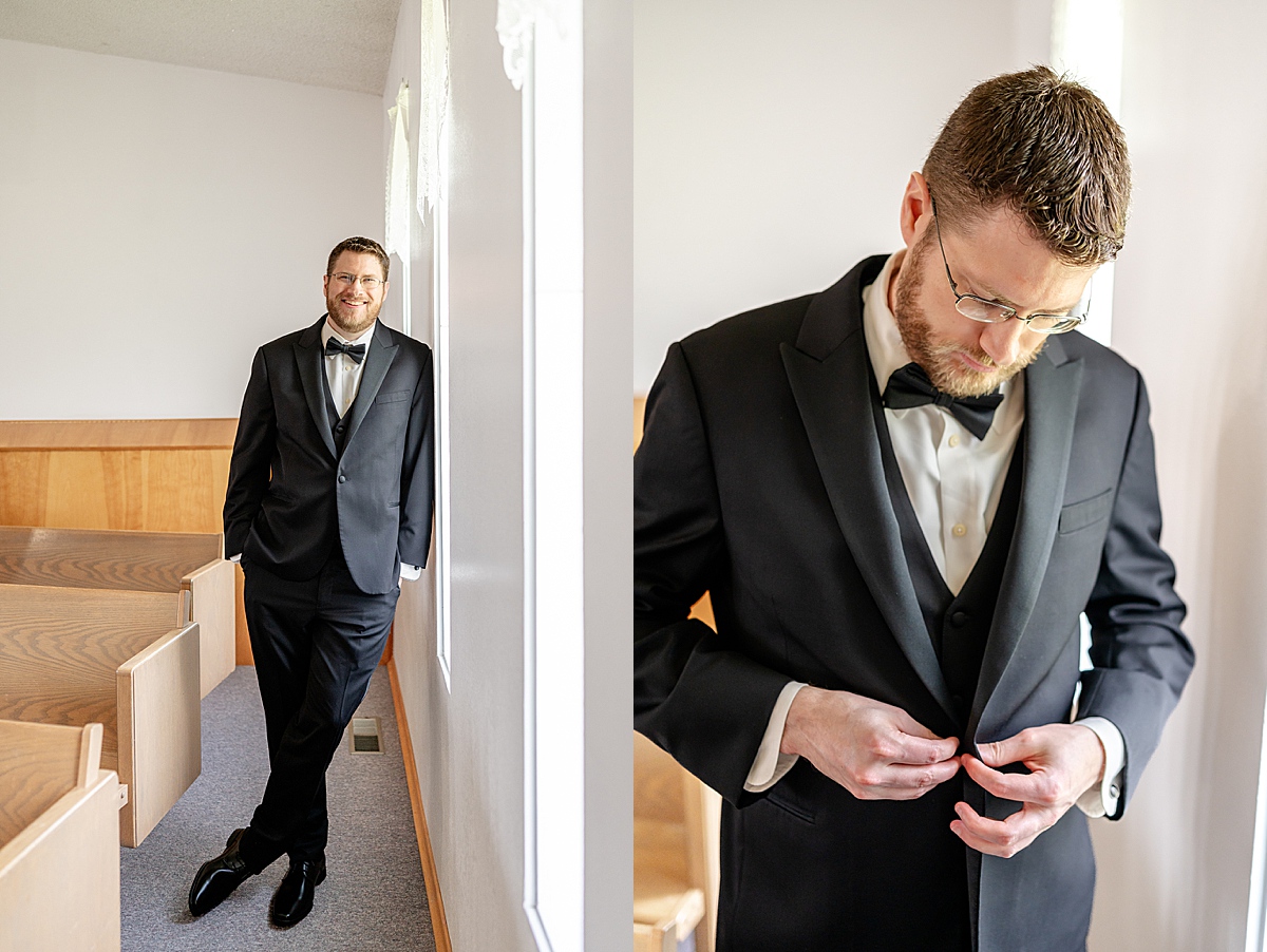Groom standing in the church, buttoning his jacket.